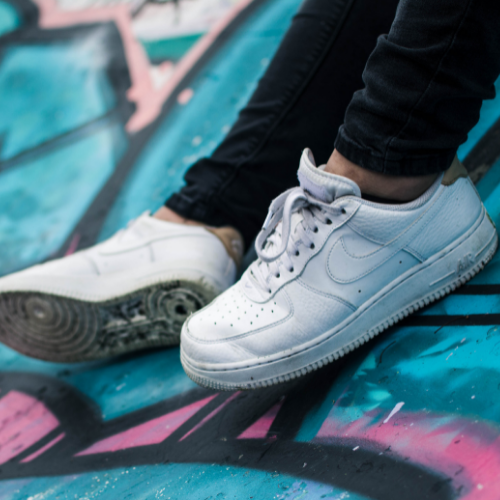 White trainers against graffiti
